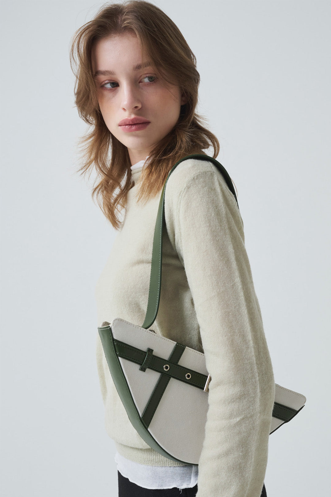 Green LE SAUT GOCHI Bag with compact design and top handle, featuring a stylish, versatile look for everyday use.