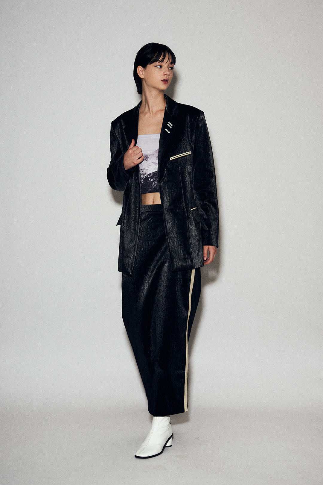 Black Eco Leather Loose-Fit Jacket by Lunecave, displayed on a hanger, featuring a relaxed fit and sleek design.