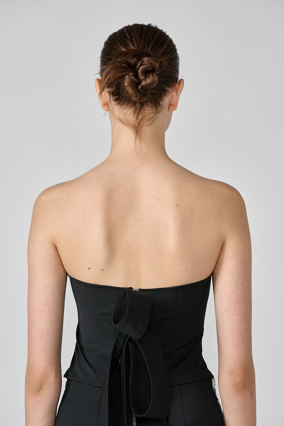 Black wool bustier top by Lunecave, featuring a fitted design and structured silhouette, displayed on a plain background.