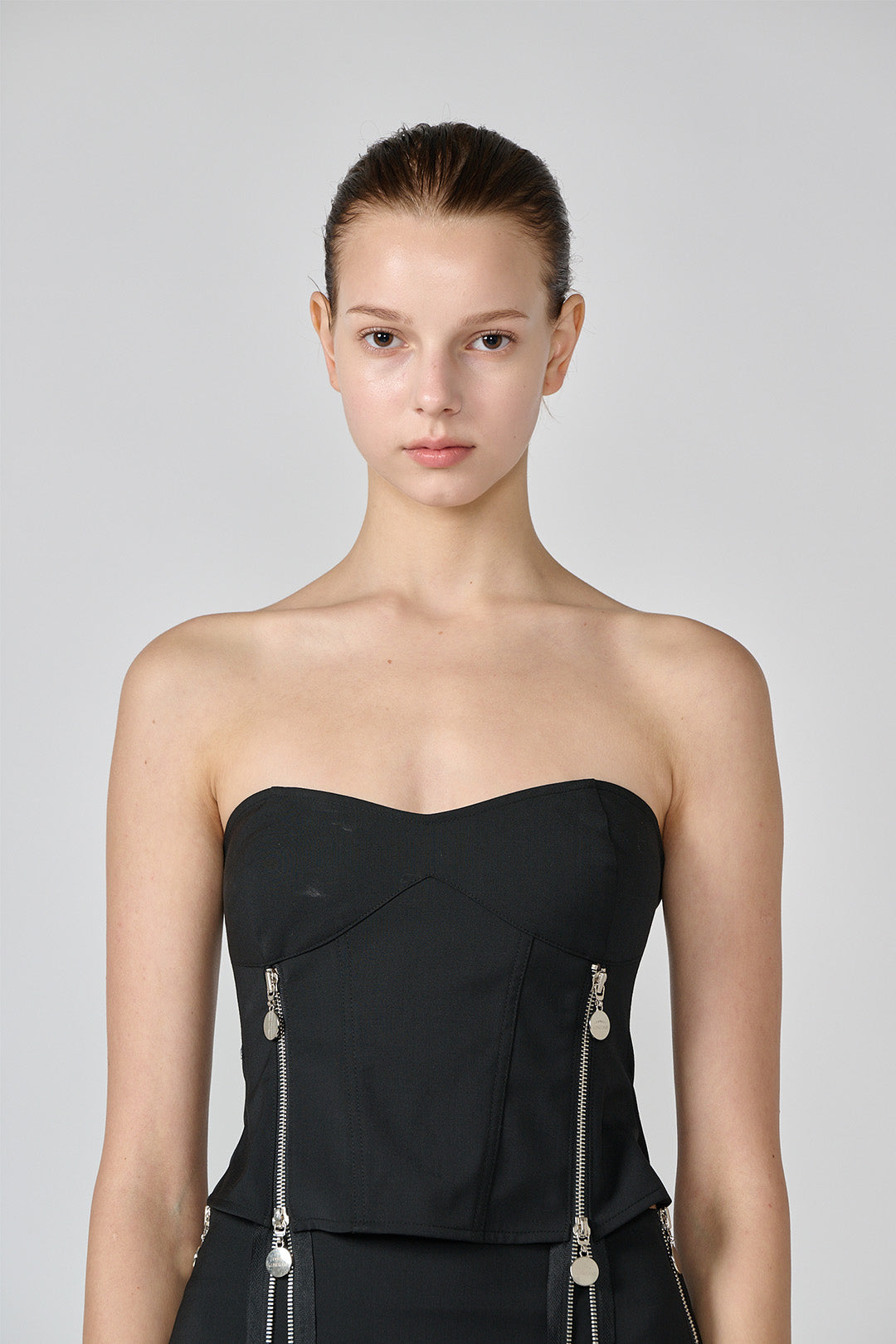 Black wool bustier top by Lunecave, close-up view showing fitted design and soft fabric texture.