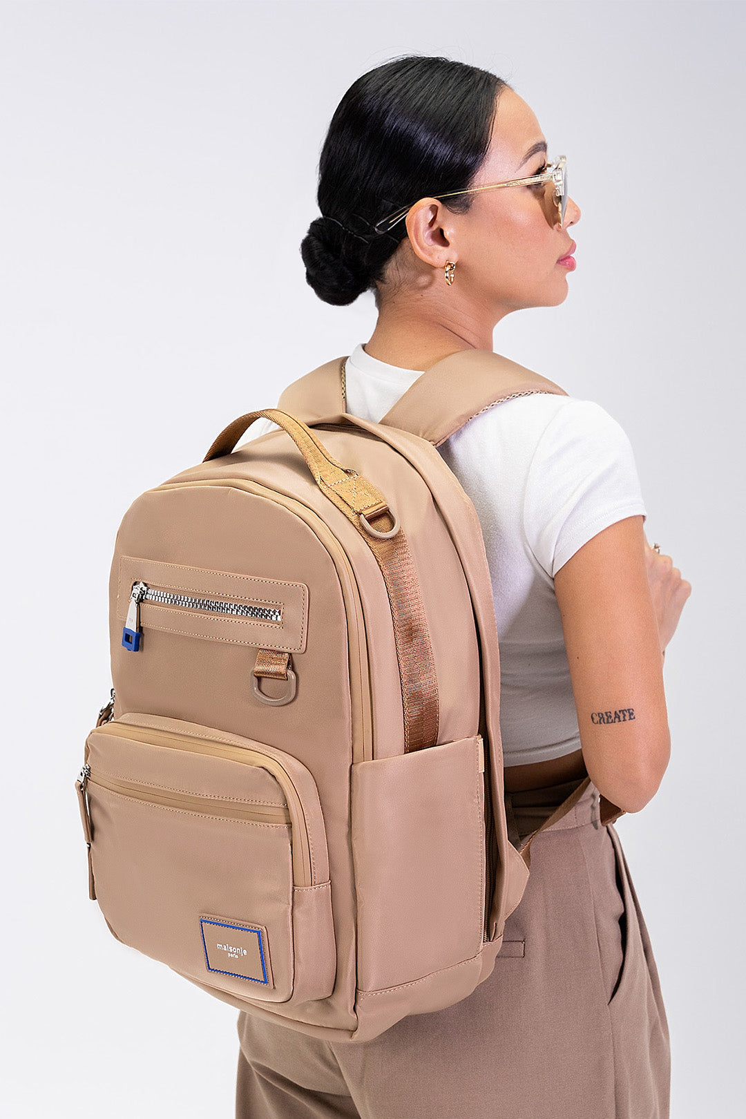 Black MAISONJE Everyday Backpack bag with adjustable straps and multiple compartments, showcasing a sleek, functional design.