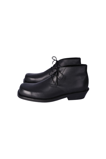 Black Nuosmiq Basa Chukka boots with lace-up design and leather material, shown close-up of the stylish footwear.