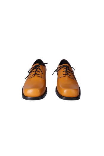 Nuosmiq Hardy Derby Mustard Derby shoe in mustard yellow leather with sleek design and lace-up closure.