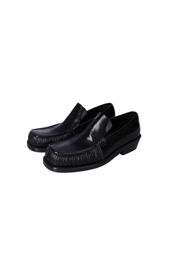 Nuosmiq Sina Winkle Black loafers showing sleek black leather with detailed stitching and classic slip-on design.