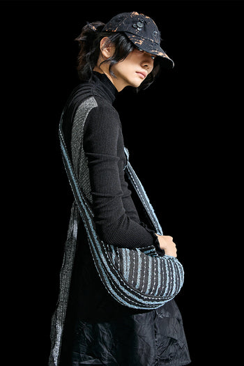 Black denim mini bag by Reculer with lace trim, featuring a compact design and adjustable strap.
