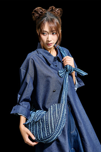 Blue denim mini bag by Reculer with lace trim, featuring a compact design and adjustable strap for casual style.