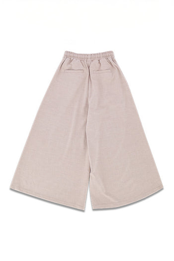 Reculer Maximal Wide Beige bottoms, one-size, with flowing fabric and relaxed fit, shown on model.