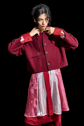 Reculer burgundy Reglan trench cropped wool coat displayed on a hanger, showcasing its tailored design and rich color.