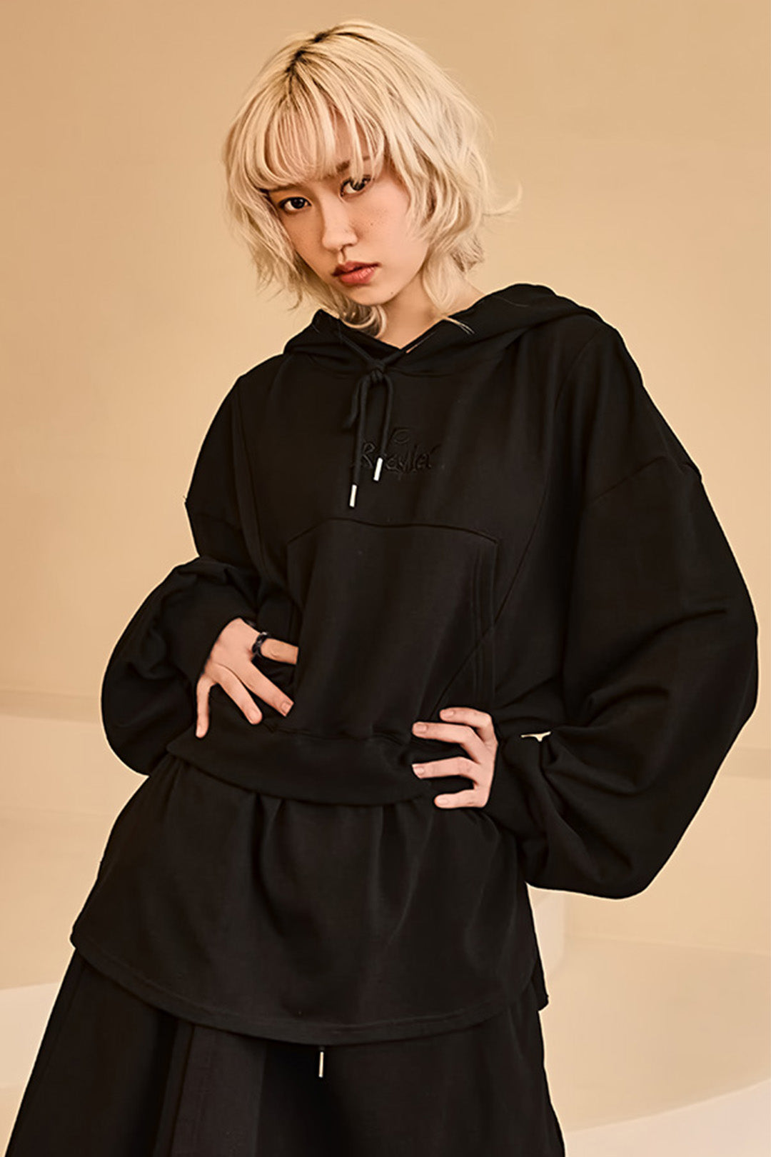 Black layered hoodie by Reculer featuring a relaxed fit, soft fabric, and a stylish layered design.