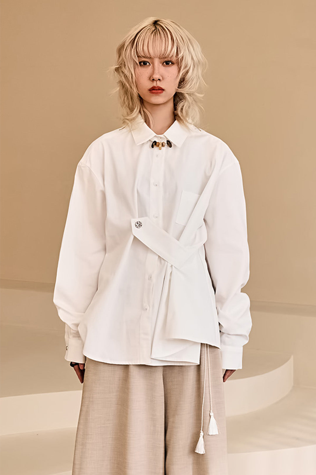 Reculer ivory draping basic shirt displayed on a hanger, showcasing soft fabric and simple, elegant design.