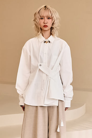 Reculer ivory draping basic shirt displayed on a hanger, showcasing soft fabric and simple, elegant design.