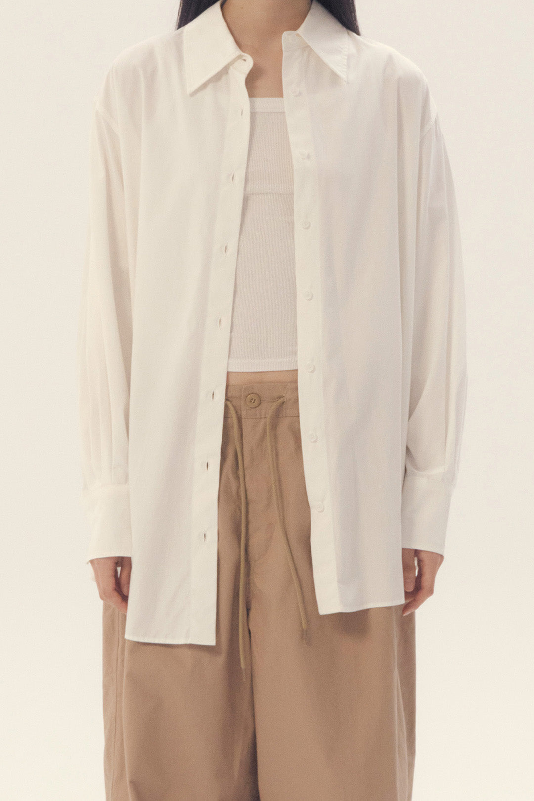 White Ribbon Back Ribbon Shirt by EUNJO, featuring a stylish back ribbon detail and classic button-up design.