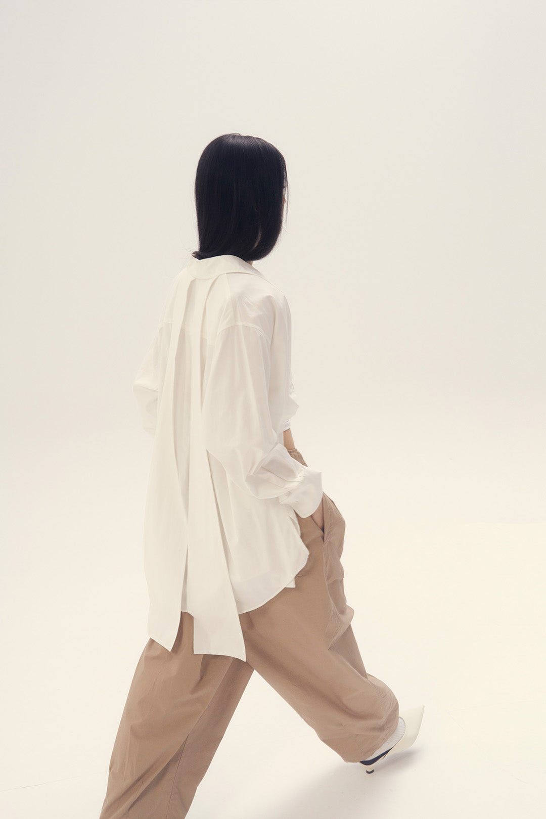 White Ribbon Back Ribbon Shirt by EUNJO, featuring a stylish ribbon detail on the back, perfect for casual or dressy occasions.