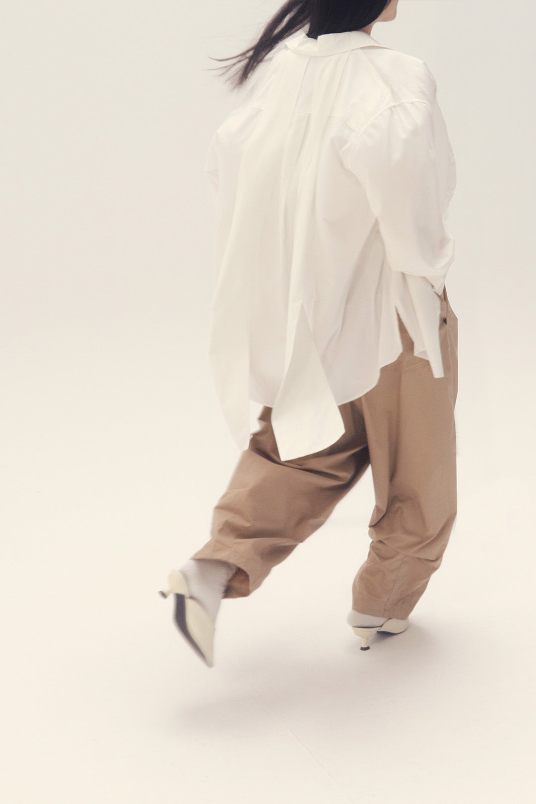 White Ribbon Back Ribbon Shirt by EUNJO featuring a stylish back ribbon detail and classic button-up design.