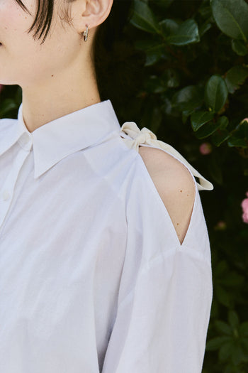White Ribbon Wings Ribbon Shirt by EUNJO, featuring a stylish design with ribbon details and a classic shirt silhouette.