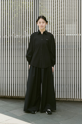 Black Ribbon Wings Ribbon Shirt by EUNJO featuring a stylish ribbon design and tailored fit, displayed on a hanger.