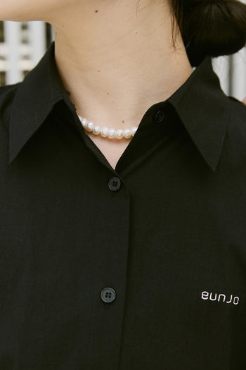 Black Ribbon Wings Ribbon Shirt by EUNJO featuring stylish ribbon detailing and a modern shirt design.