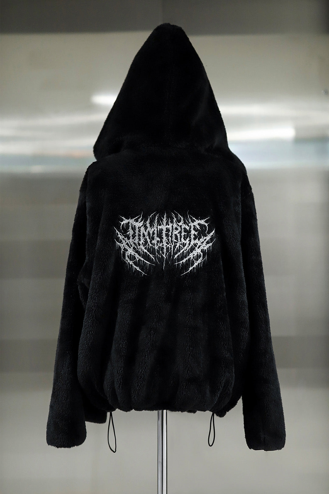 Black TM3 Balaclava Fleece Hoodie with hood and adjustable fit, designed for warmth and comfort.