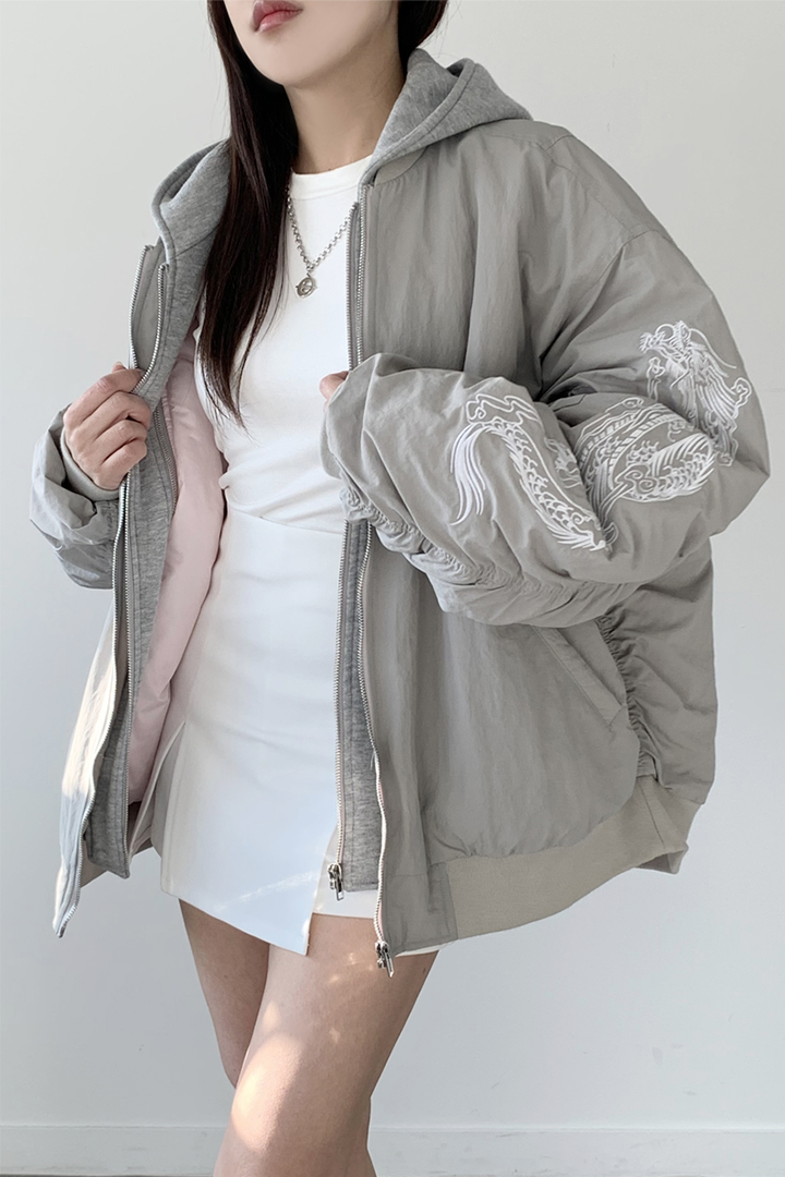 White bomber jacket by TM3 with beige and grey dragon embroidery, featuring a stylish casual design.