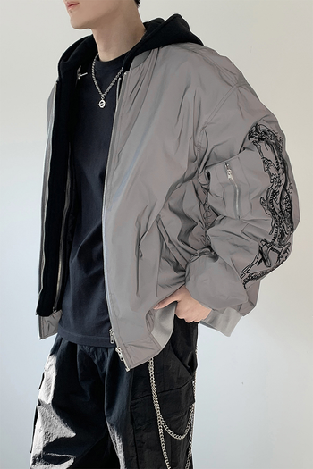 Black bomber jacket by TM3 featuring grey dragon embroidery and reflective accents, shown with front zipper and ribbed cuffs.