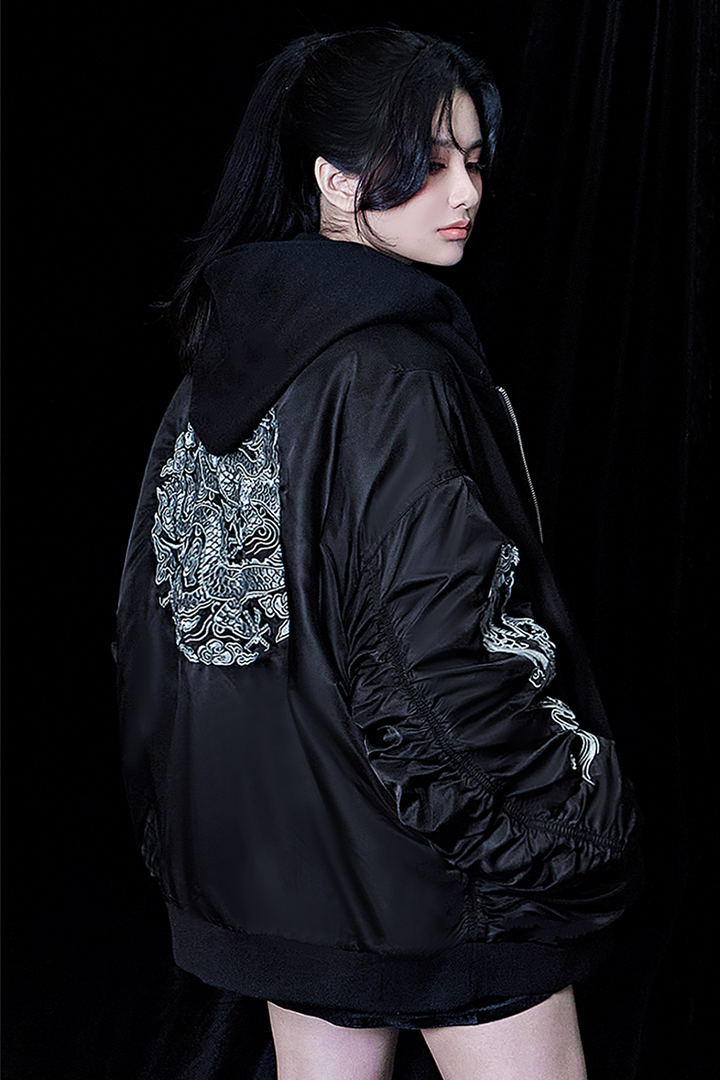 Black TM3 bomber jacket featuring detailed dragon embroidery, with a sleek design and ribbed cuffs and collar.