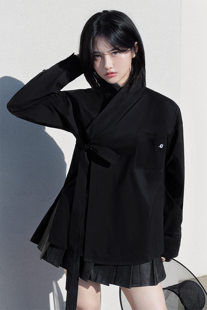 Black TM3 classic hanbok shirt, traditional Korean garment with a simple, elegant design, displayed flat on a white background.