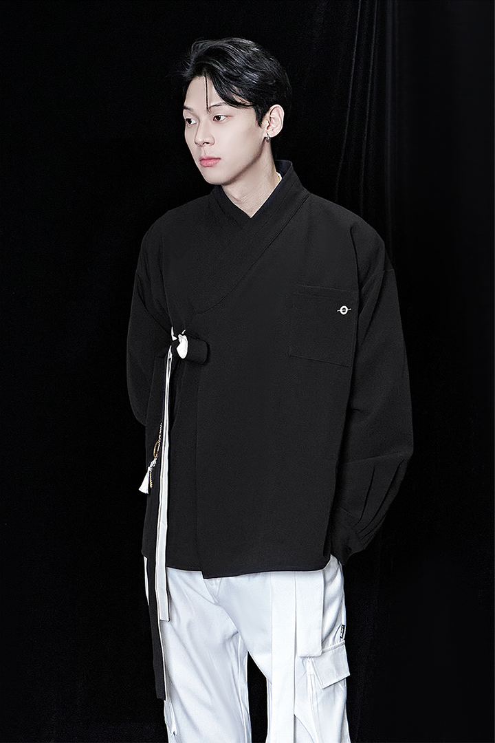 Black oversized shirt by TM3, displayed flat, showing relaxed fit and classic collar, made from soft fabric.