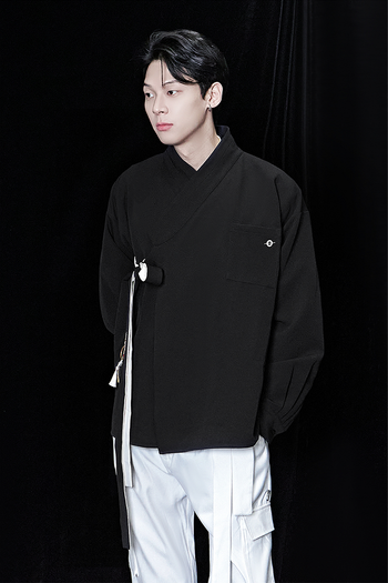 Black oversized shirt by TM3, displayed flat, showing relaxed fit and classic collar, made from soft fabric.