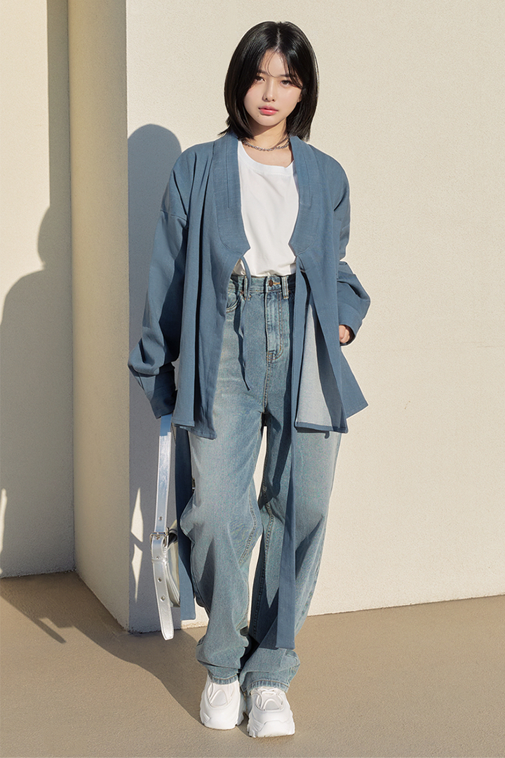 Light denim TM3 shirt jacket displayed on a hanger, showcasing classic button-up design and casual style.