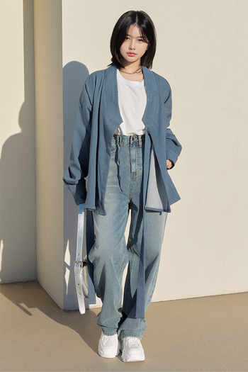 Light denim TM3 shirt jacket displayed on a hanger, showcasing classic button-up design and casual style.
