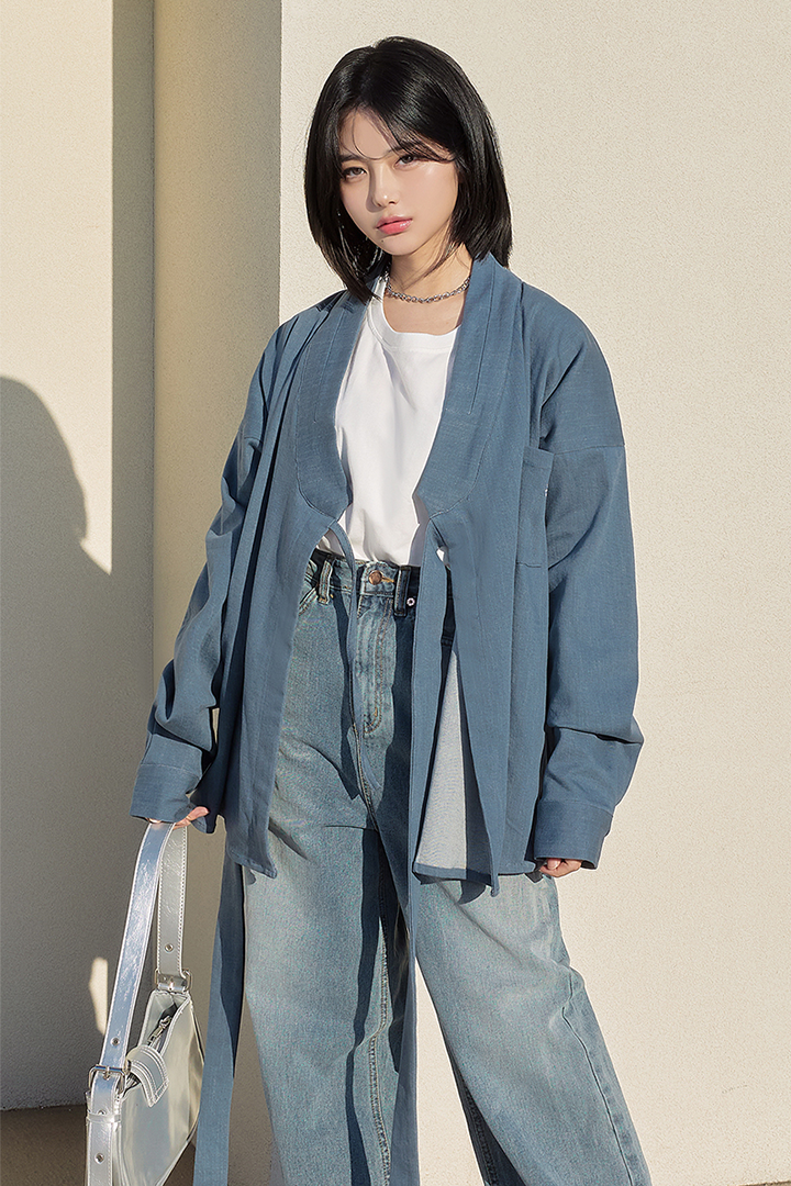 Light denim TM3 shirt jacket displayed on a hanger showing front view with classic collar and button closure.