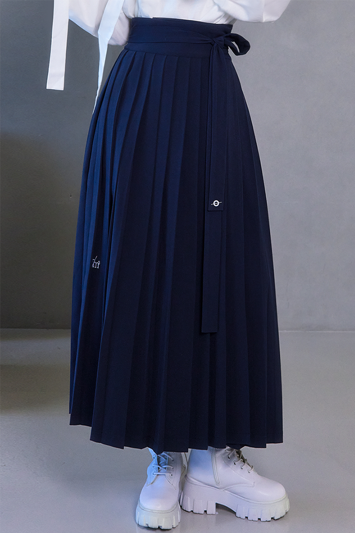 Deep Sea Navy Pleated Skirt by TM3, shown in navy fabric with elegant pleats, designed for a stylish, feminine look.