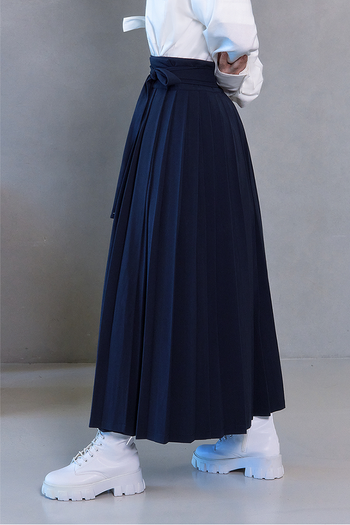 Deep Sea Navy pleated skirt by TM3, shown in navy color with a structured pleated design, styled as a shirt.