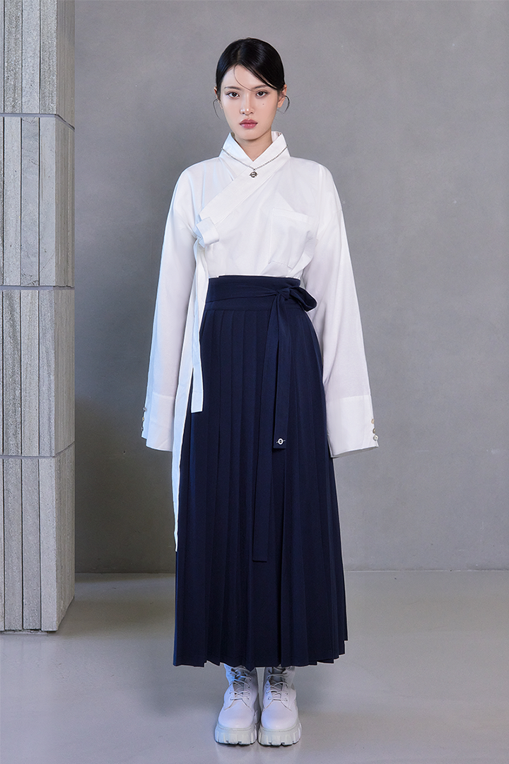 Deep Sea Navy Pleated Skirt by TM3, shown in navy fabric with elegant pleats, designed for a stylish, feminine look.