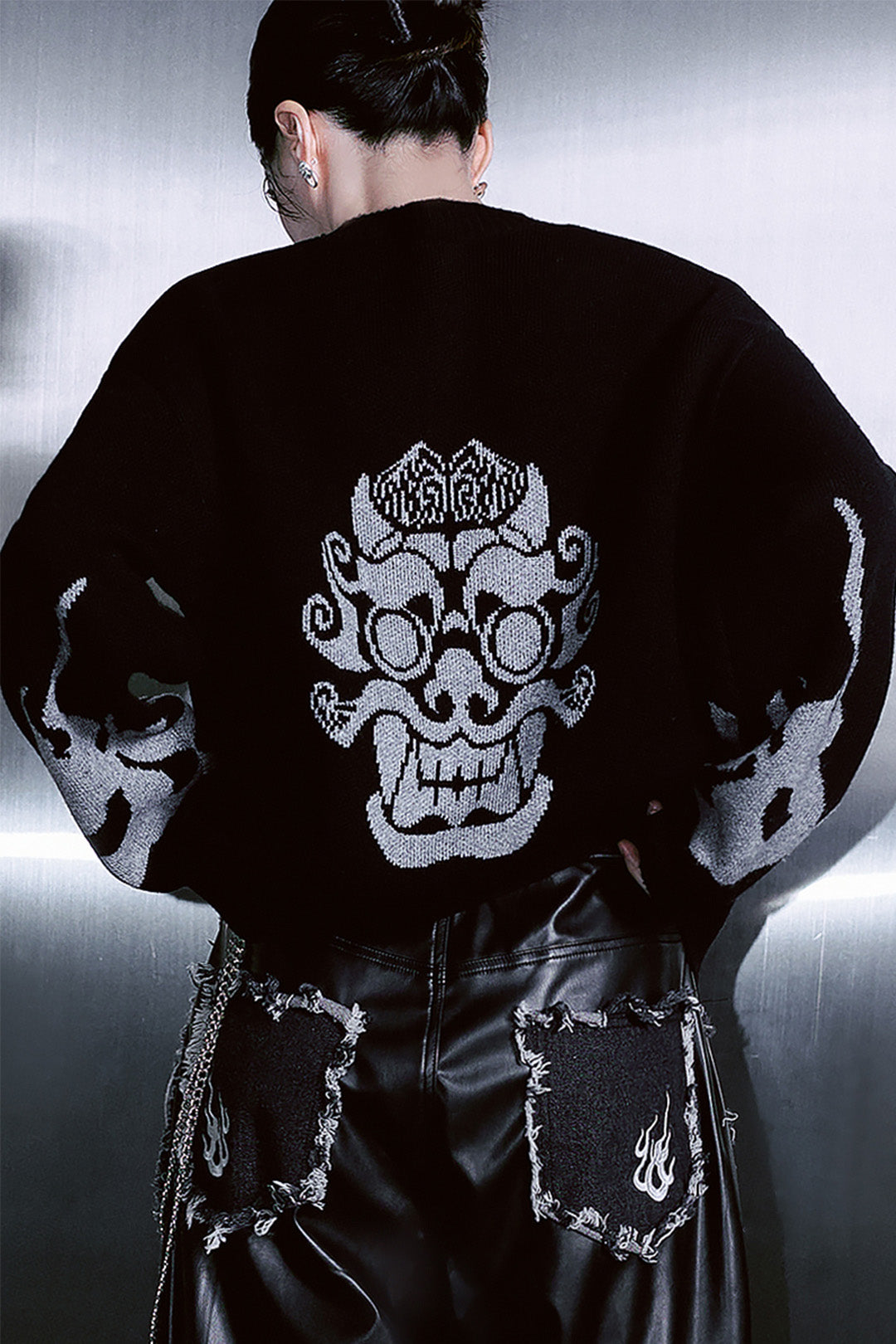 Black TM3 traditional Korean Dokkaebi face merino wool knit sweater, close-up of detailed face embroidery on the front.