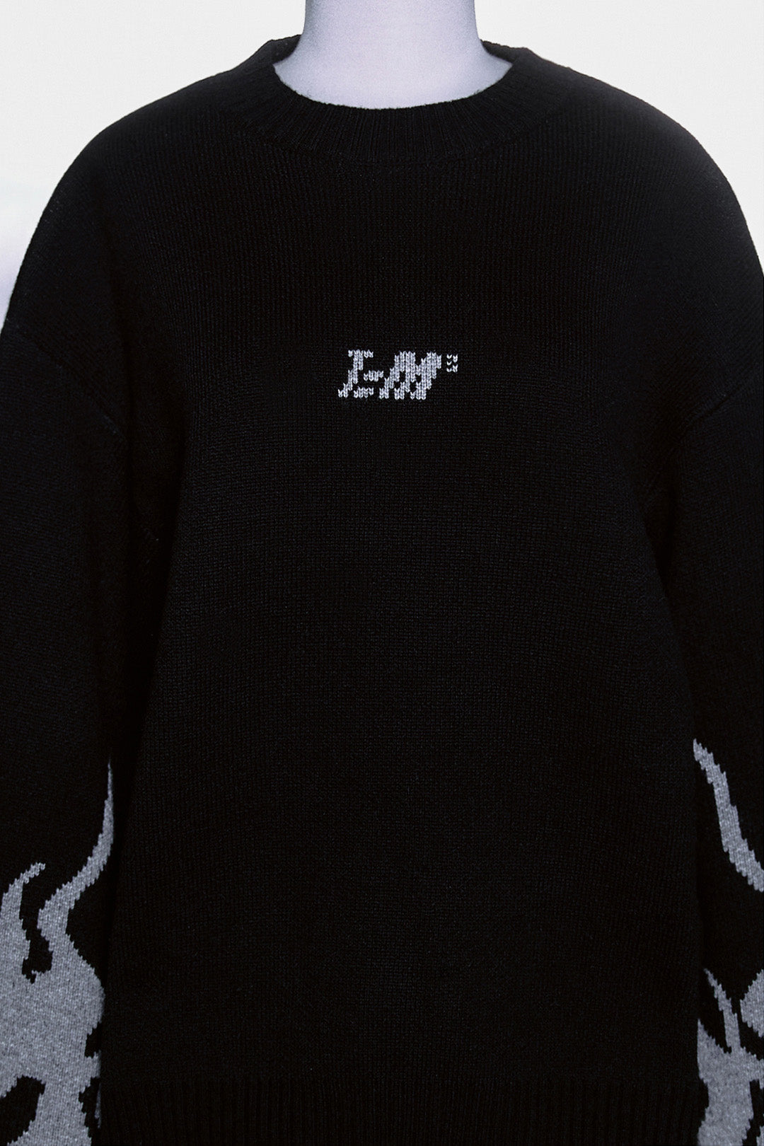 Black TM3 traditional Korean Dokkaebi face merino wool knit sweater, featuring detailed embroidery on the front.