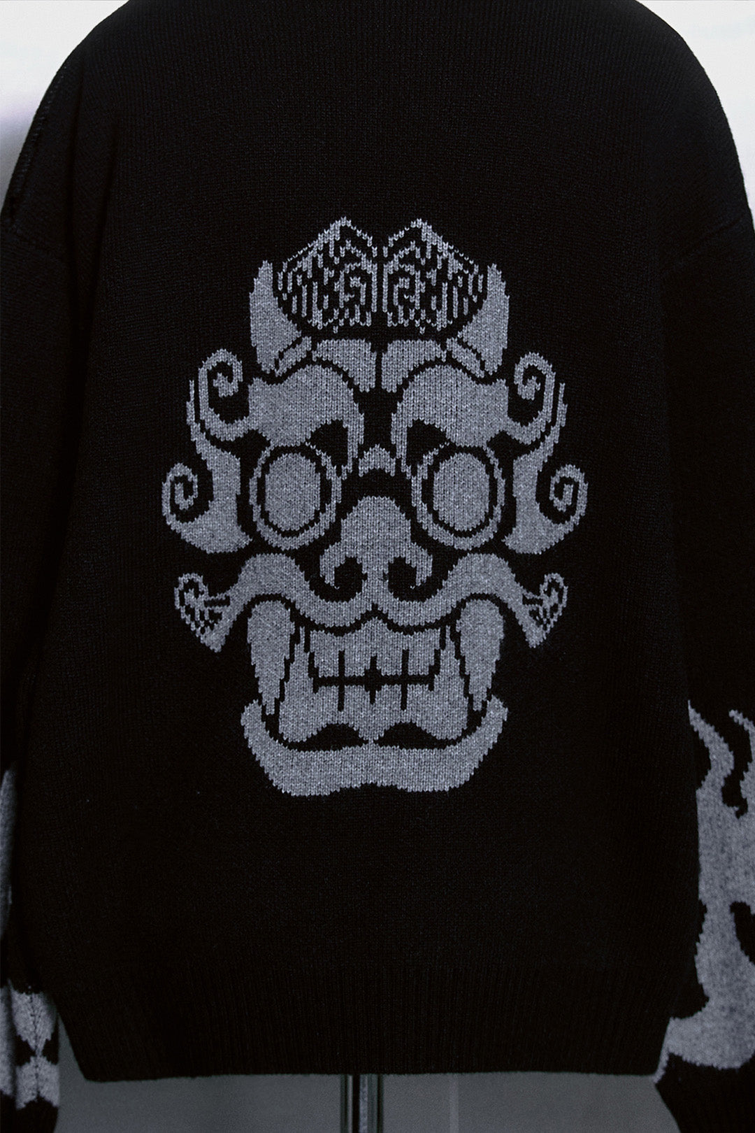 Black TM3 Korean Dokkaebi face merino wool knit sweater, featuring traditional design and detailed embroidery on the front.