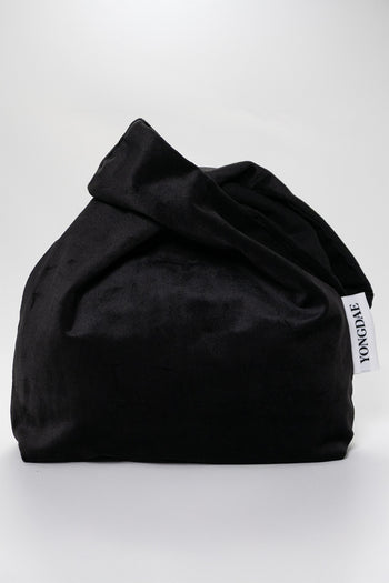 Black YONGDAE K-Beauty fashion bag with sleek design, featuring multiple compartments and stylish branding.